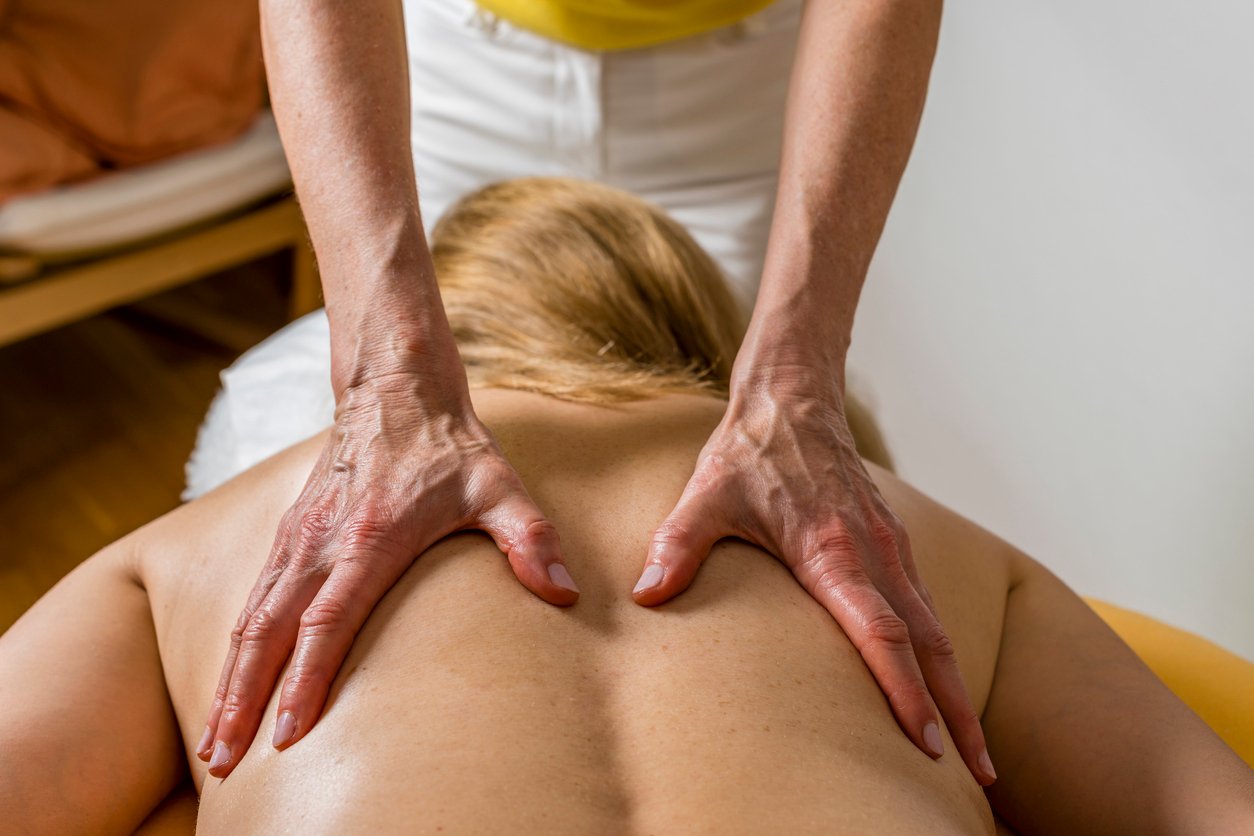woman enjoying therapeutic massage in spa